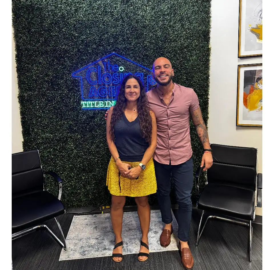Jose with a smiling client at the title office on closing day