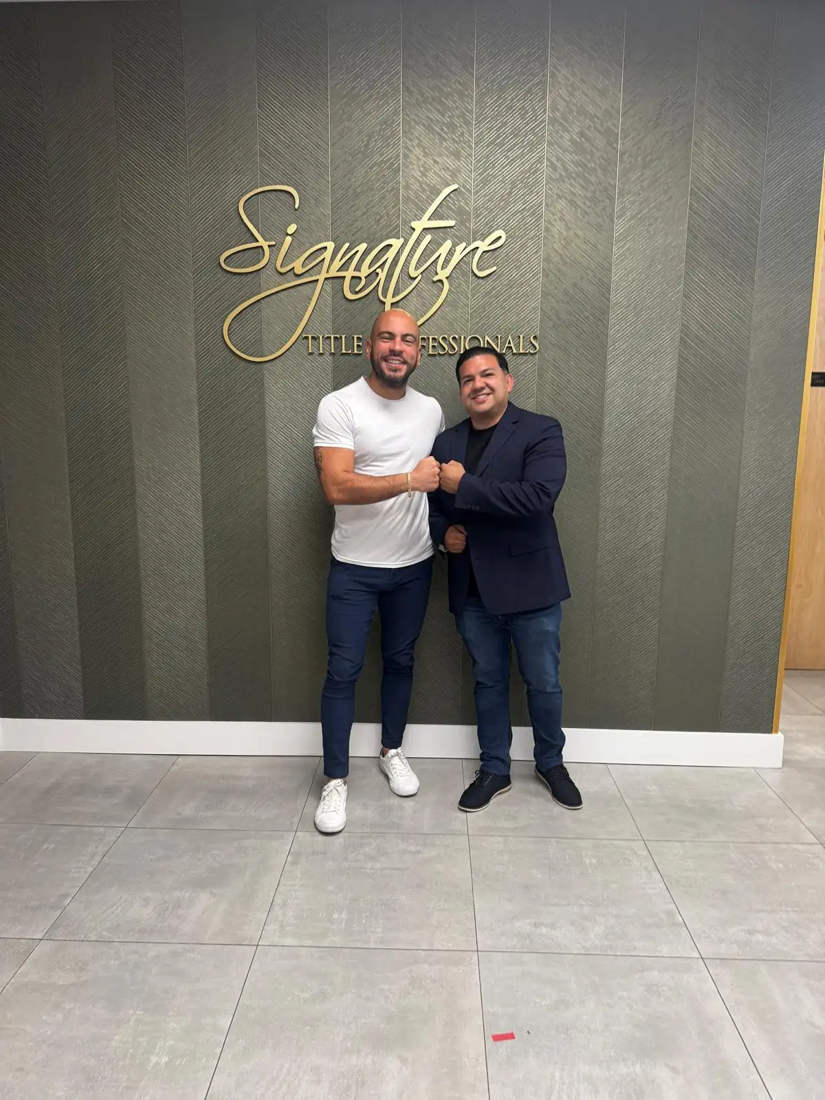 Jose and a client sharing a fist bump at Signature Title Professionals